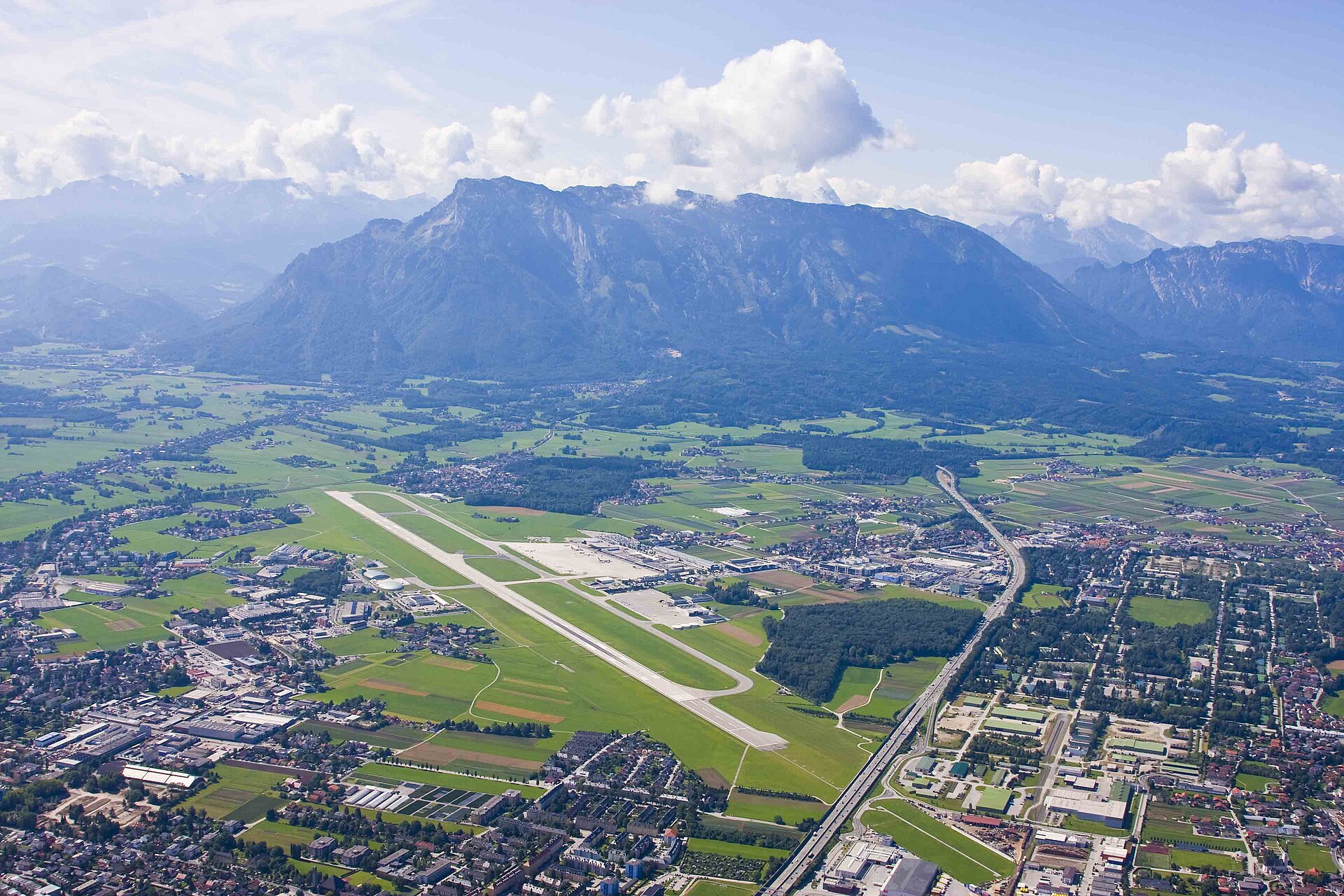 Aerial view of Salzburg Airport (SZG) with terminal, apron and runway